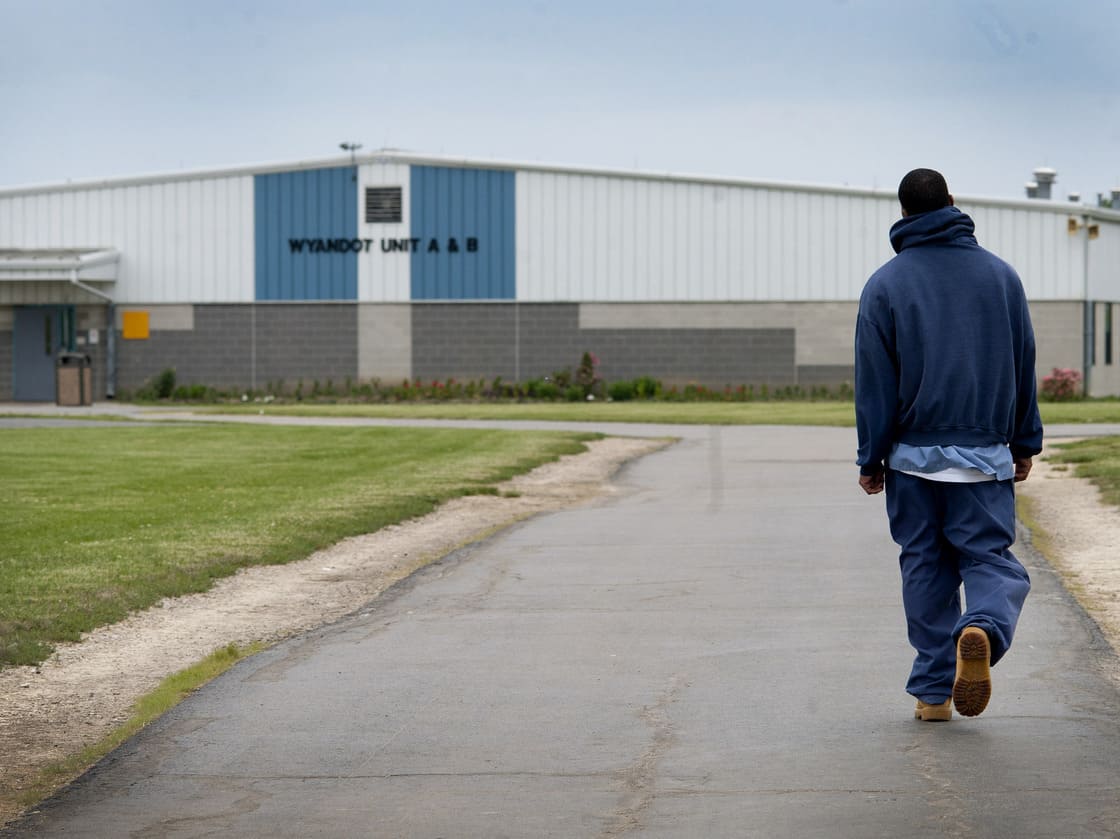 An inmate walks through the yard at the North Central Correctional Institution in Marion, Ohio, which recently switched to private management